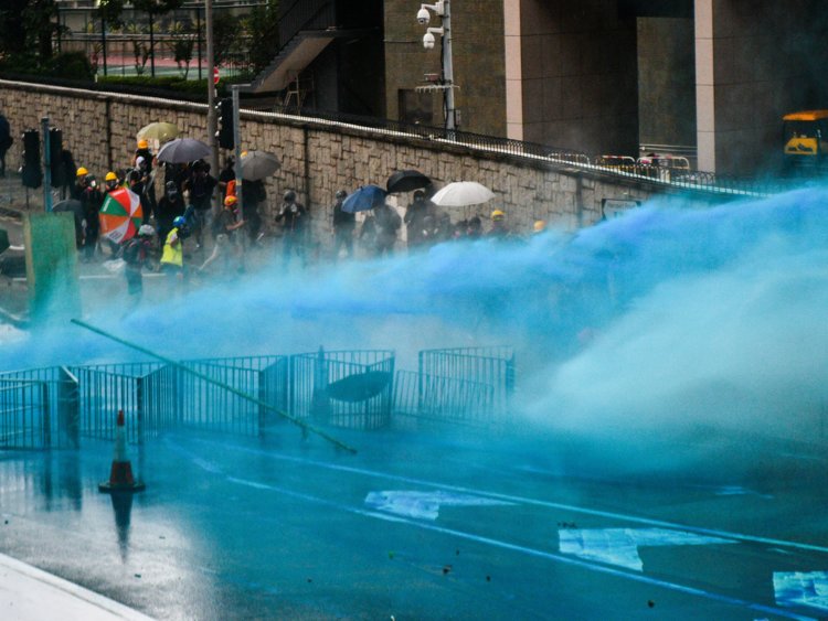 Hong Kong police fire  blue-dyed water cannons at protesters